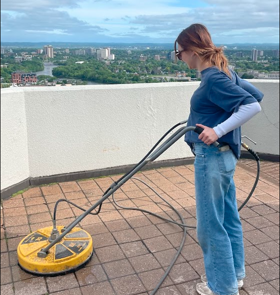 Interlock Cleaning. Woman cleaning interlock deck.